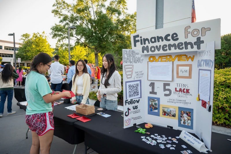 Finance For Movement outreach booth at a community festival.